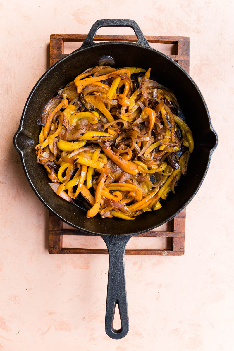 Cooked peppers and onions in cast iron skillet.