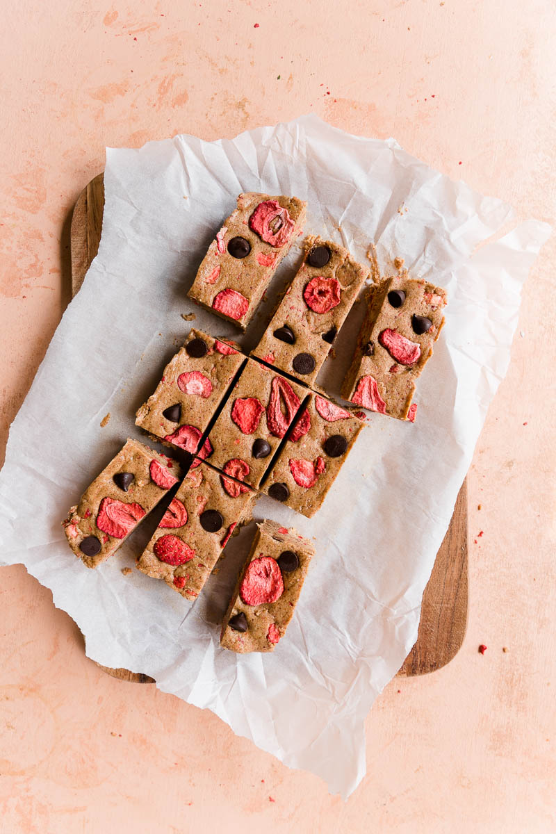 Strawberry protein bars cut on parchment paper.