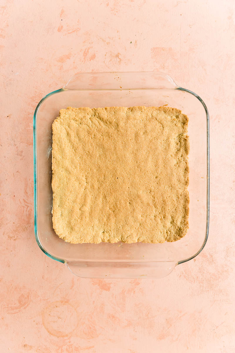 Baked shortbread crust in square pan.