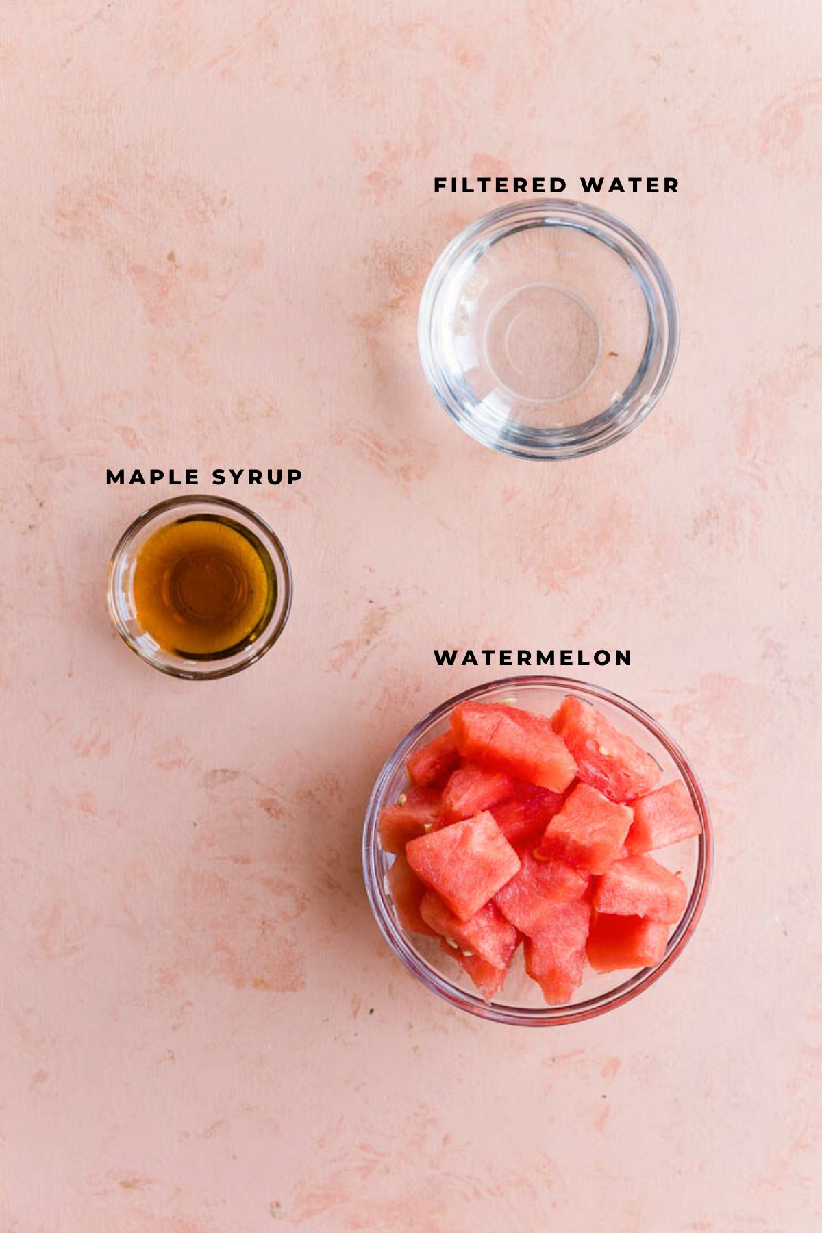 Ingredients measured out in small bowls for watermelon italian ice.