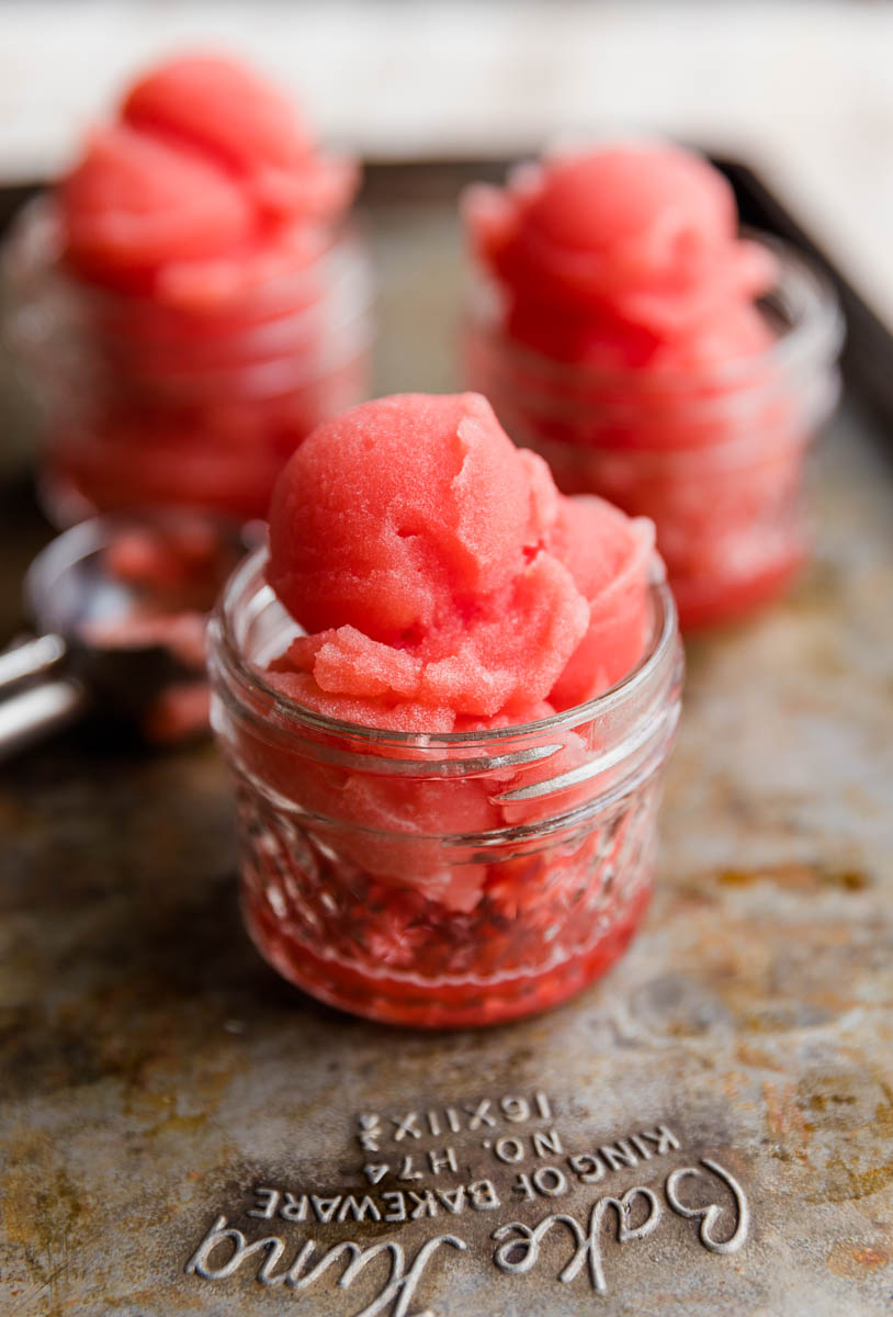 Close up picture of watermelon italian ice in a glass cup.