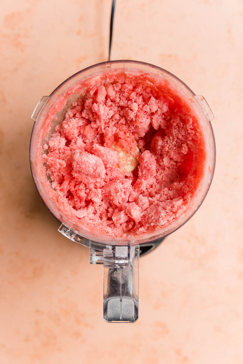 Frozen watermelon half blended in a food processor.