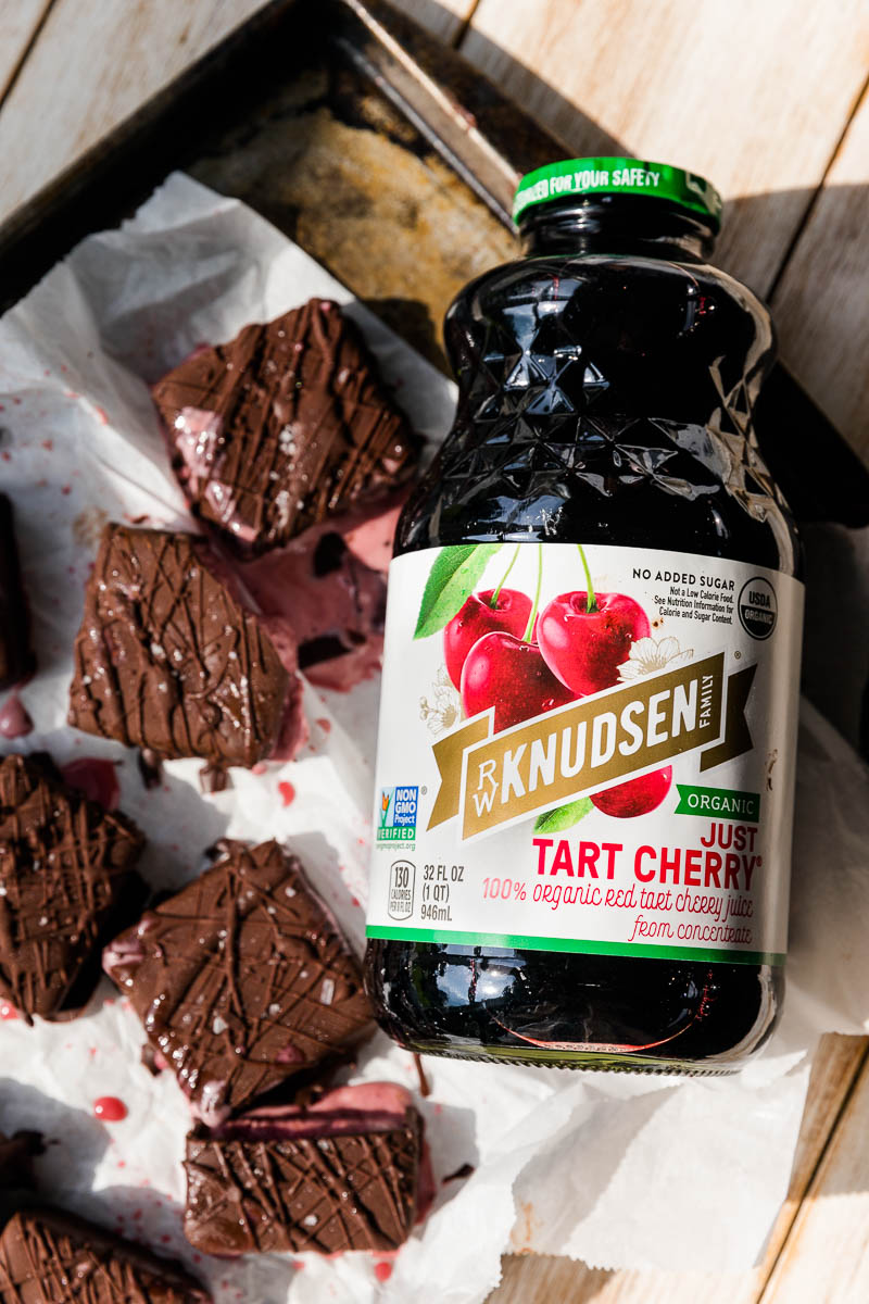 Bottle of tart cherry juice next to ice cream bars.