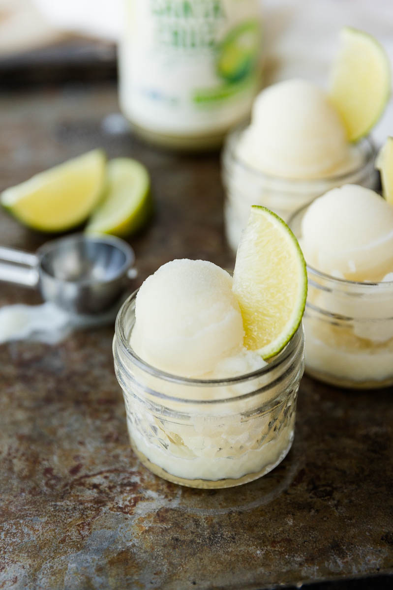 Lime Sorbet in cup with lime wedge on the side.