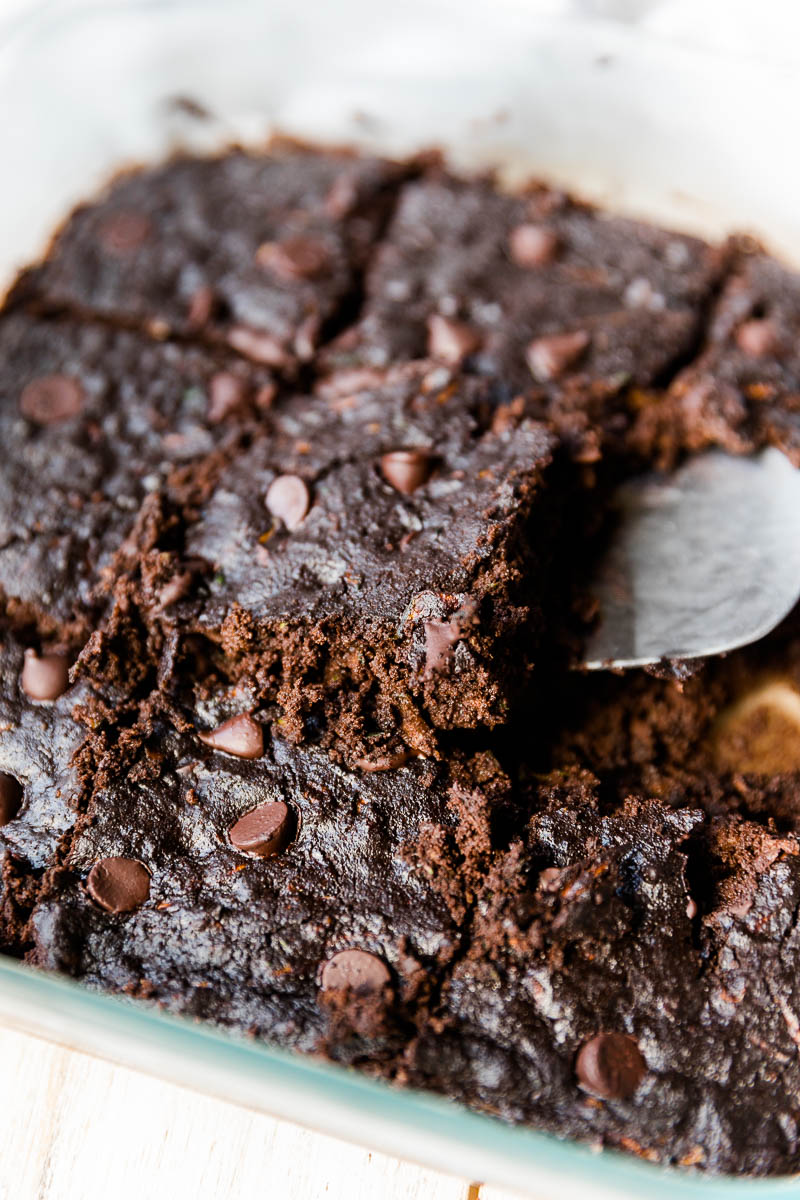 Spatula scooping out double chocolate zucchini bars. 