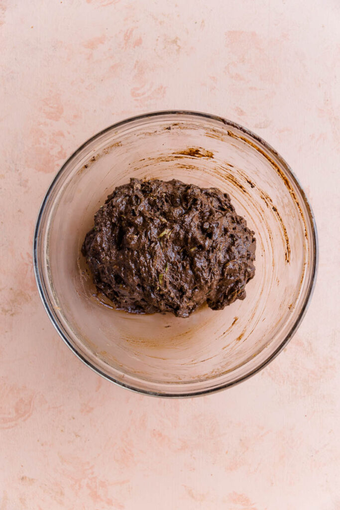 Zucchini bar batter in a glass mixing bowl.