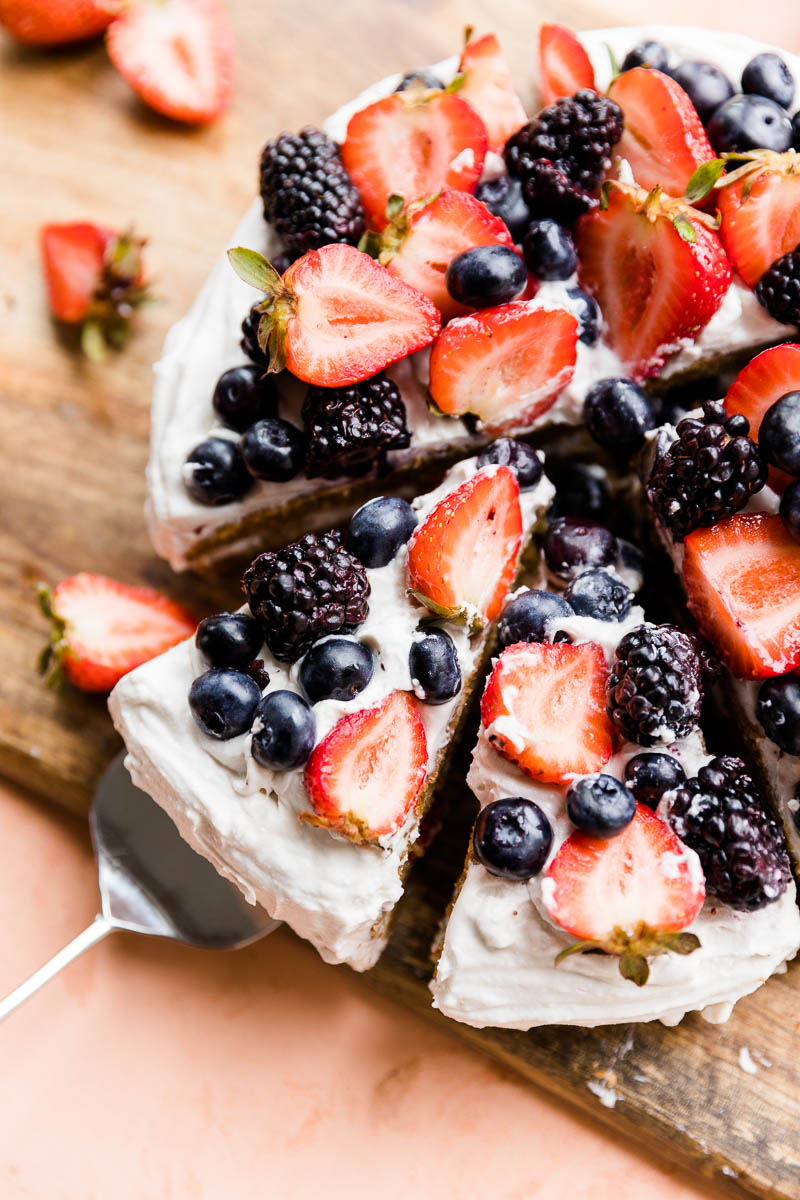 Slice of chantilly cake being pulled out by serving spoon.