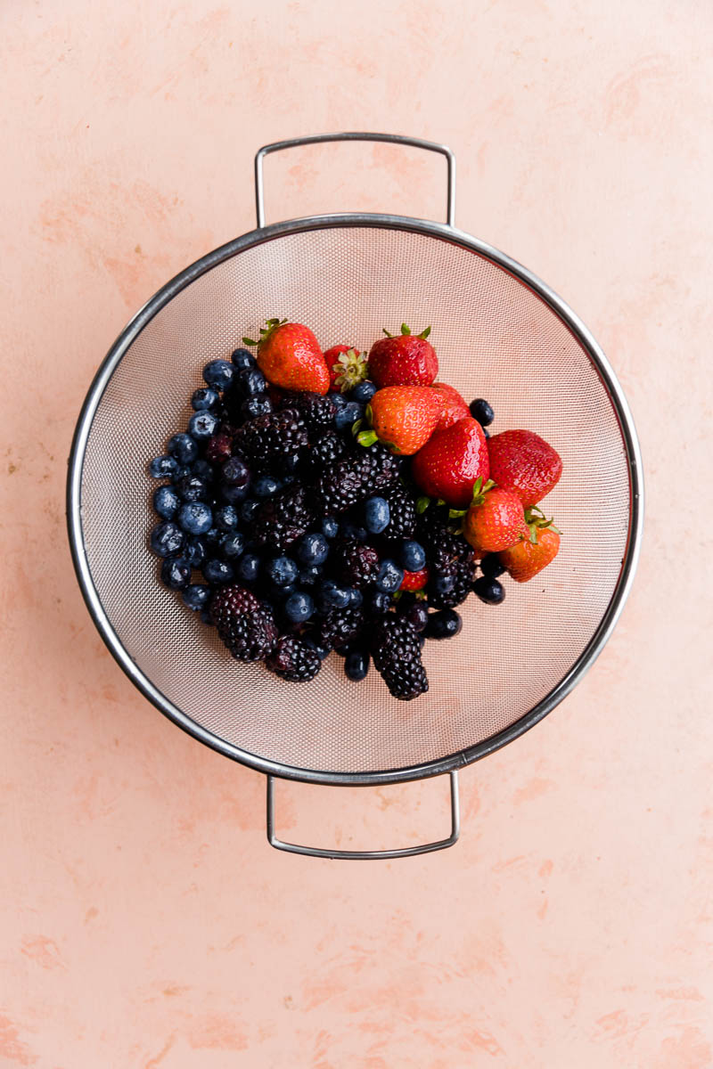 Rinsed fruit in strainer.
