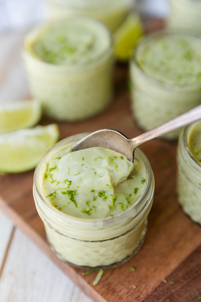 Creamy avocado lime pudding with a spoon scooping it out.