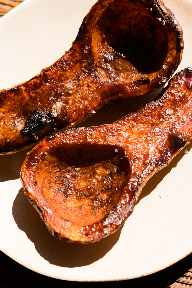Sunlight hitting caramelized butternut squash halves.
