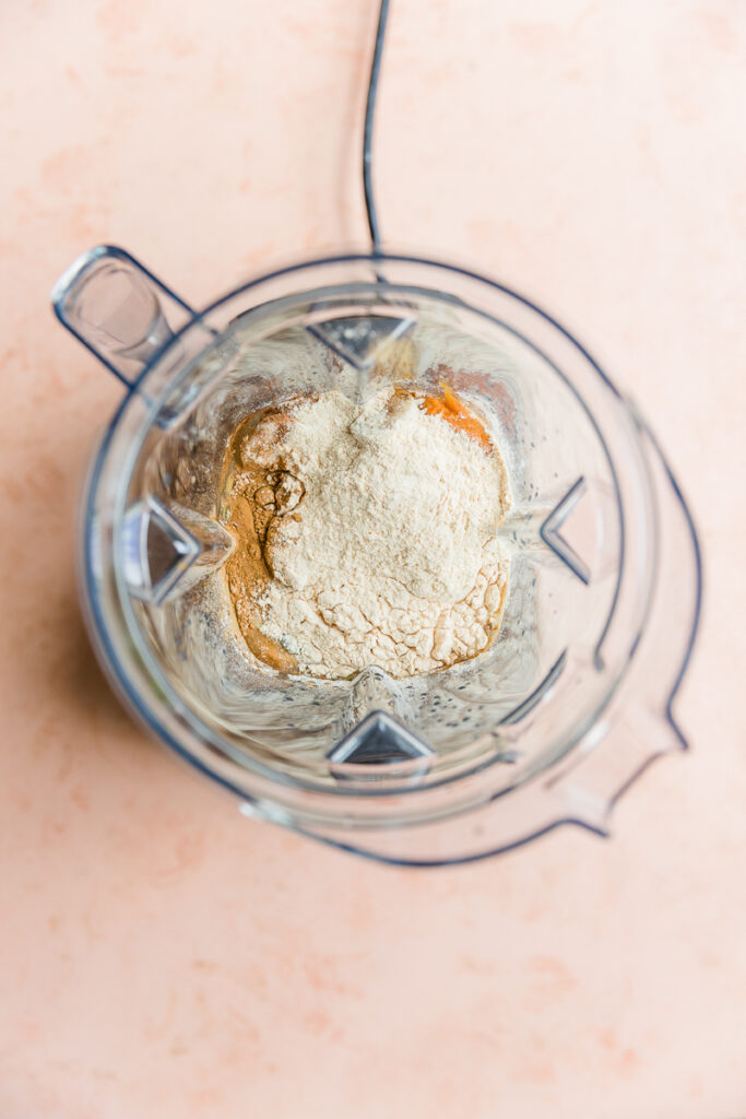 Pumpkin pie protein shake ingredients in blender.