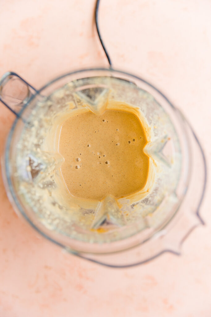 Smooth and creamy pumpkin smoothie in blender.