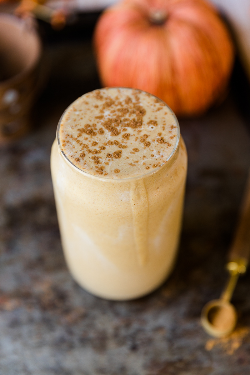 Close up picture of pumpkin pie smoothie with pumpkin spice on top.