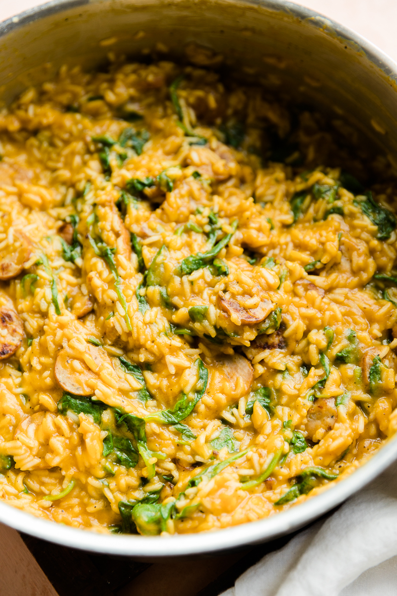 Creamy chicken sausage and rice in pan.