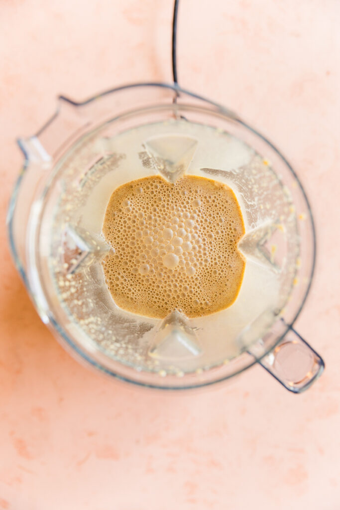 Frothy pumpkin spice creamer in blender.