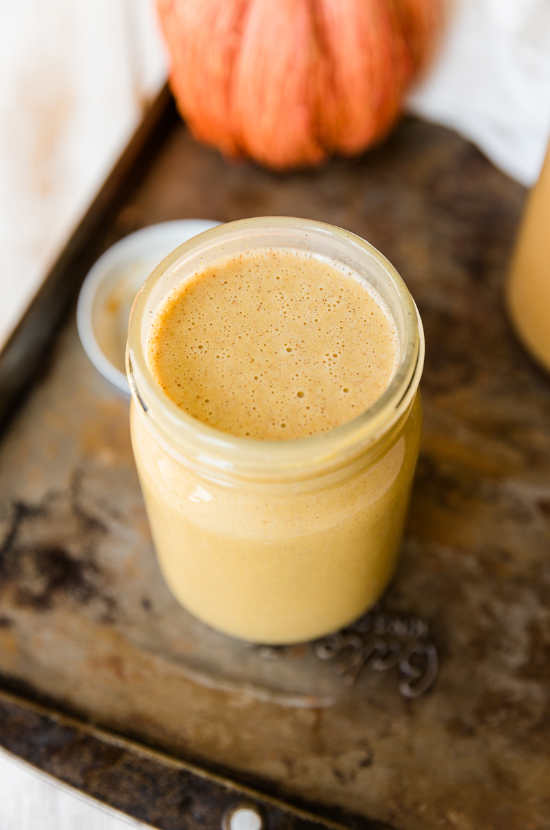 Close up of pumpkin spice coffee creamer in mason jar.