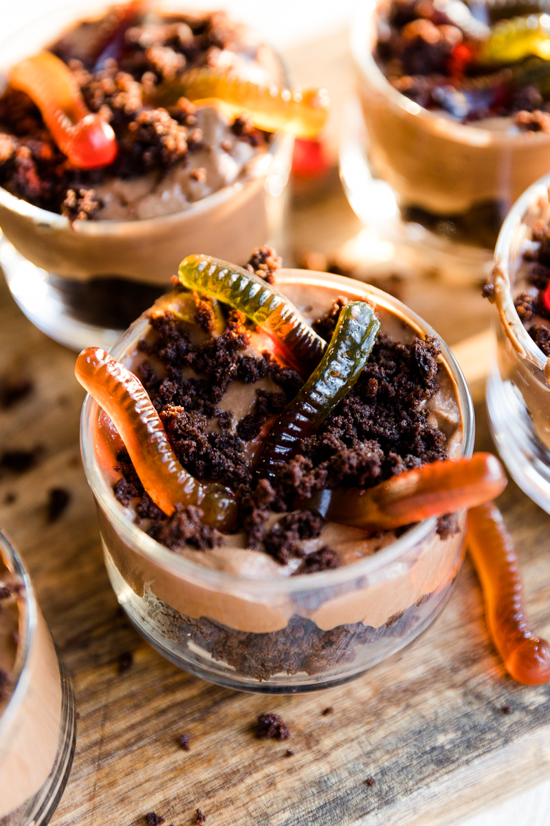 Halloween dirt cups with gummy worms sticking out.