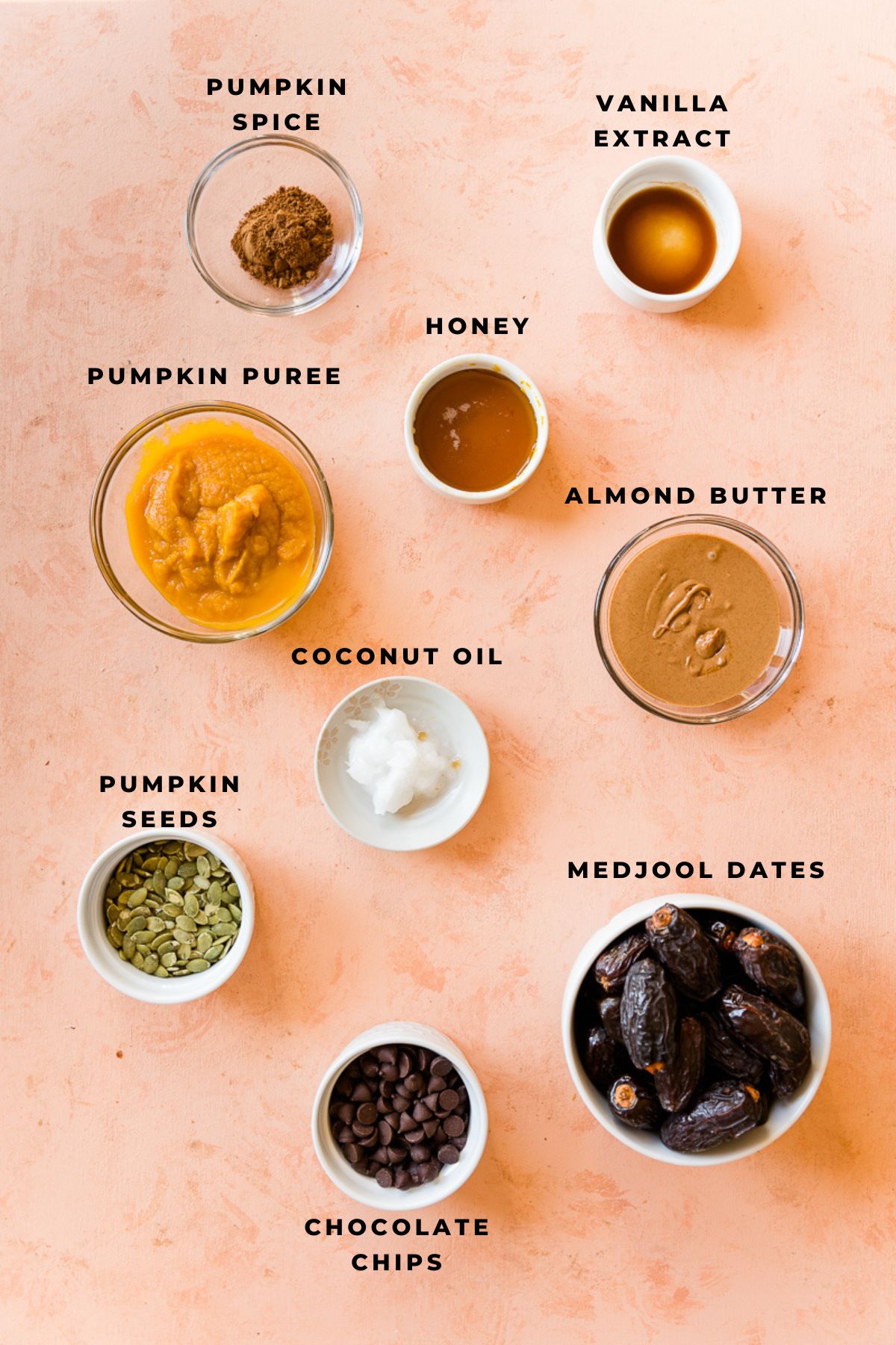 Ingredients measured out in small bowls for pumpkin spice date bark.