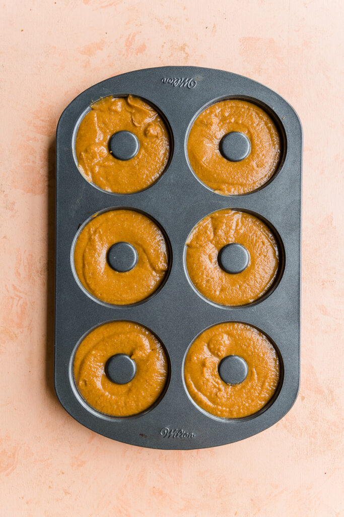 Donut batter in donut pan.