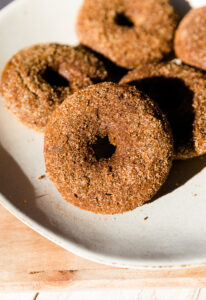 Fluffy pumpkin spice donut coated in cinnamon and sugar.