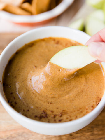 Apple dipped into creamy pumpkin pie dip.
