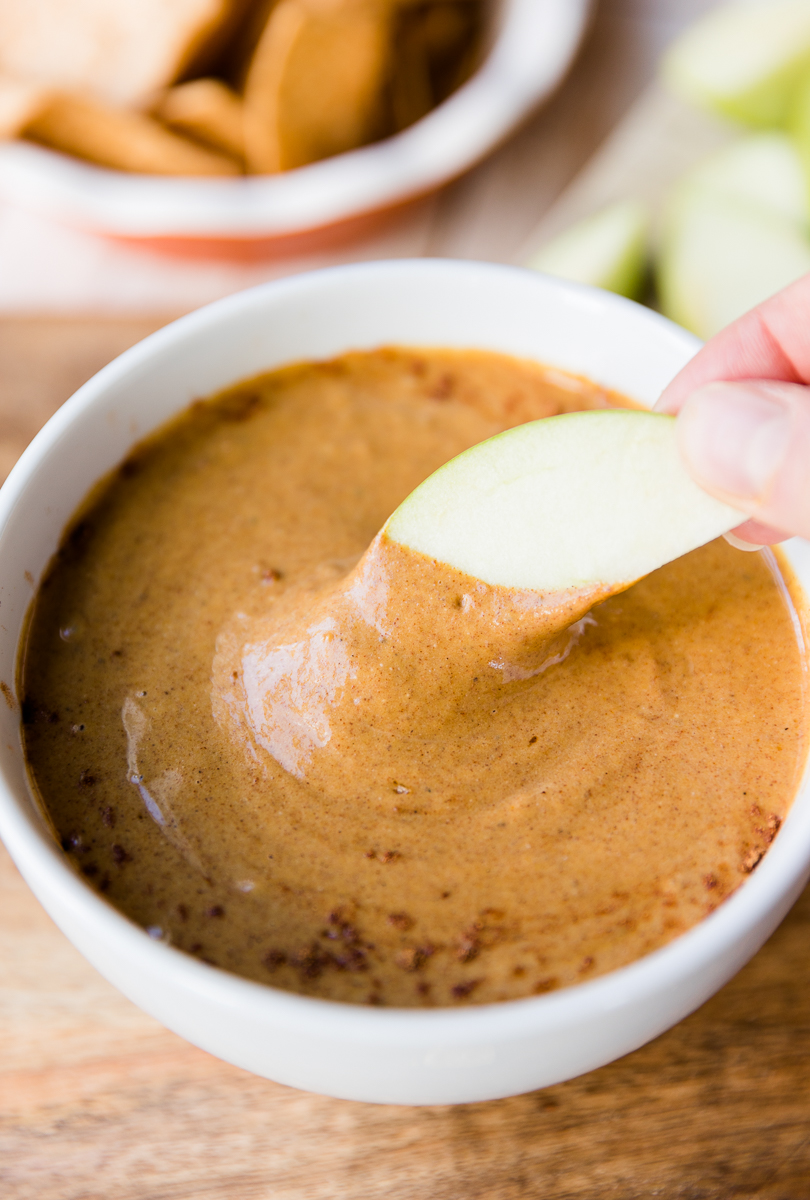 Apple dipped into creamy pumpkin pie dip.