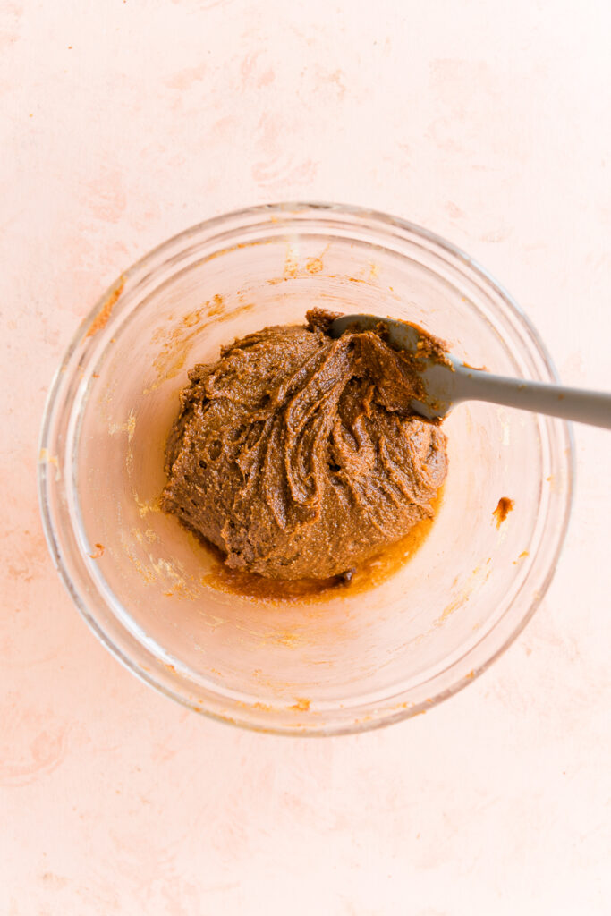 Pumpkin protein bar dough in a mixing bowl with spatula.