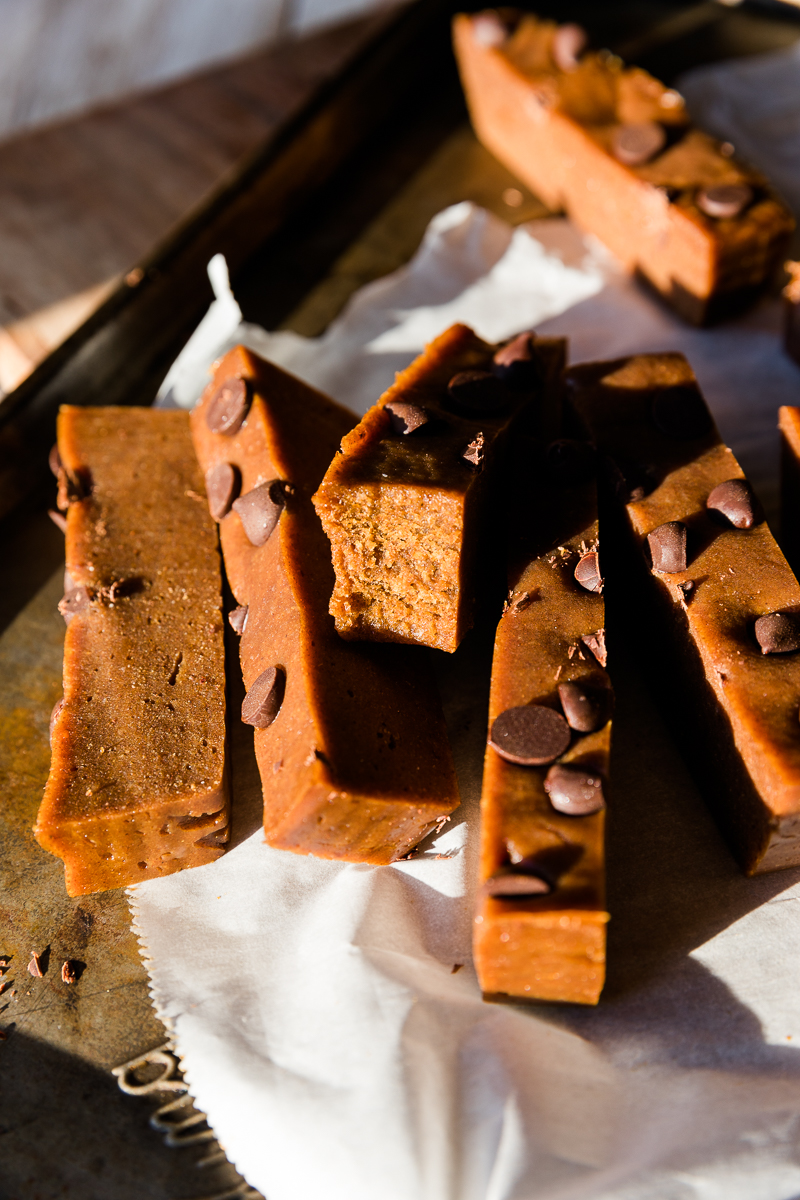 Pumpkin protein bar with a bite taken out.