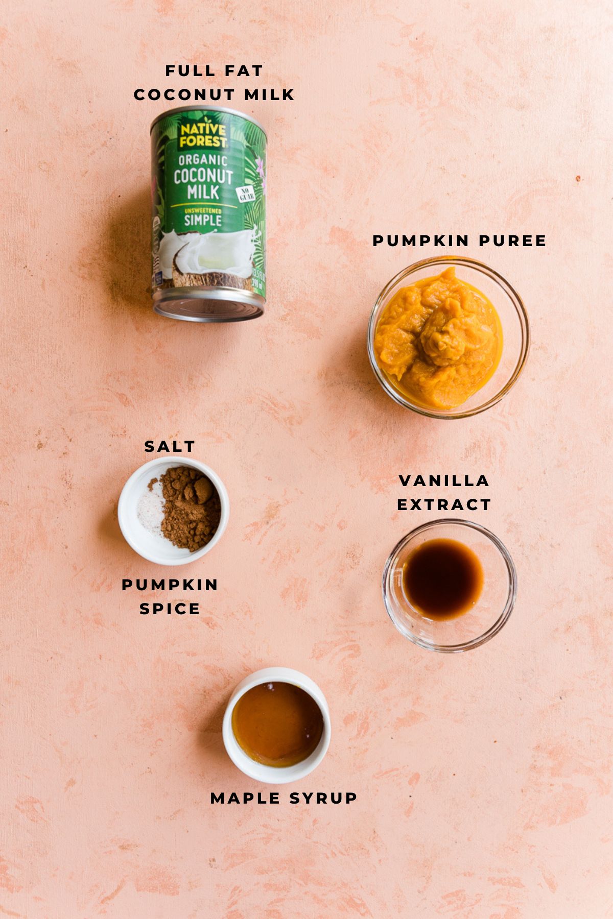 Ingredients measured out in small bowls for pumpkin spice creamer.