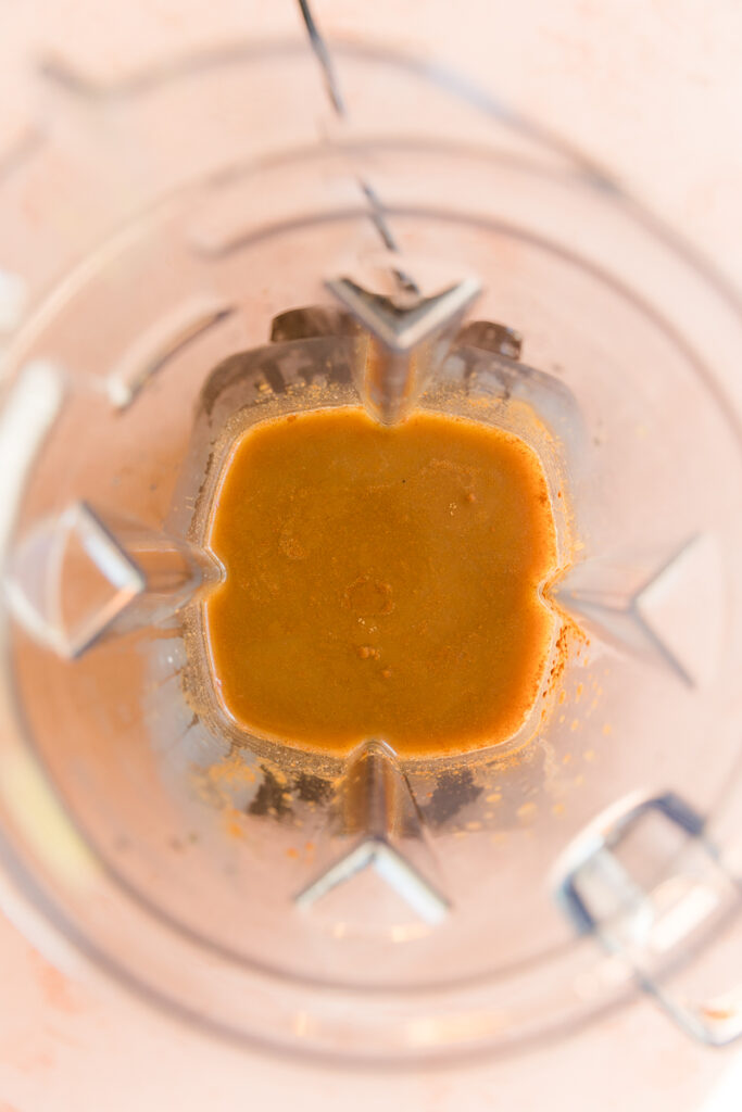 Pumpkin spice coffee ingredients in blender.