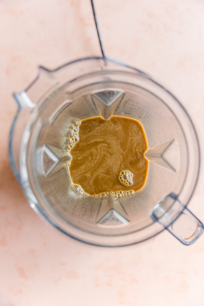 Blended pumpkin spice coffee in blender.