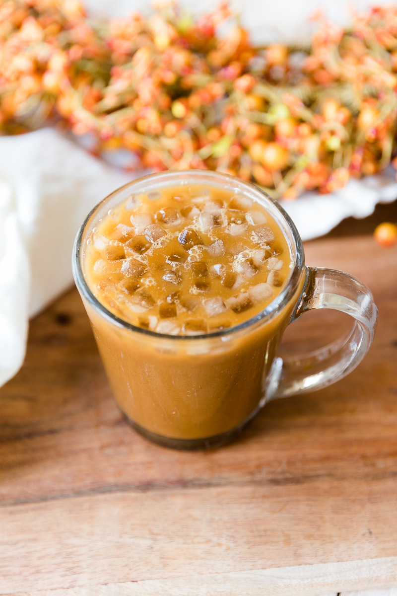Pumpkin spice coffee in clear glass mug.