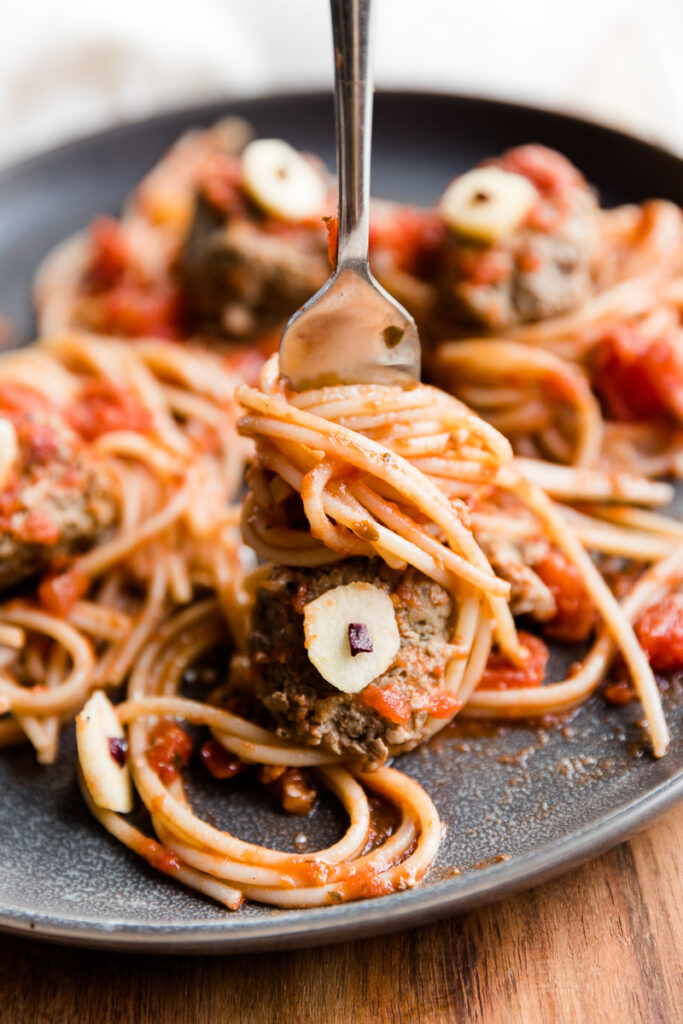 Fork stuck in meatball with zombie eye.