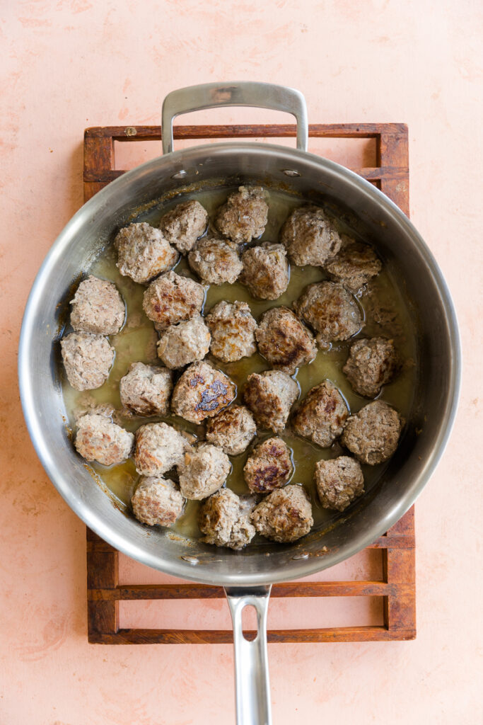 Meatballs cooked in a pan.