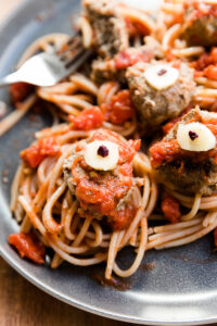 Zombie eye meatballs with sauce and spaghetti.