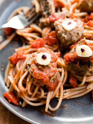 Zombie eye meatballs with sauce and spaghetti.