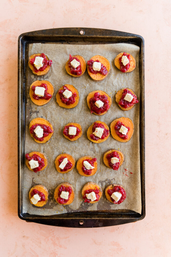 Sweet potato discs topped with cranberry sauce and dairy free brie cheese.