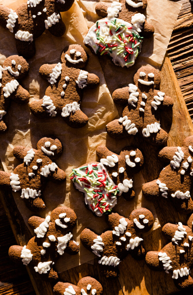 Frosted gingerbread men cookies on parchment paper.
