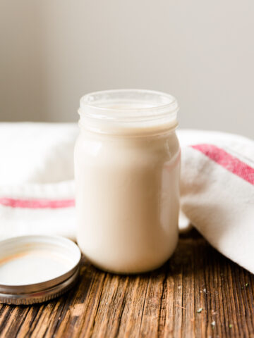 Dairy free vanilla creamer in small glass mason jar.