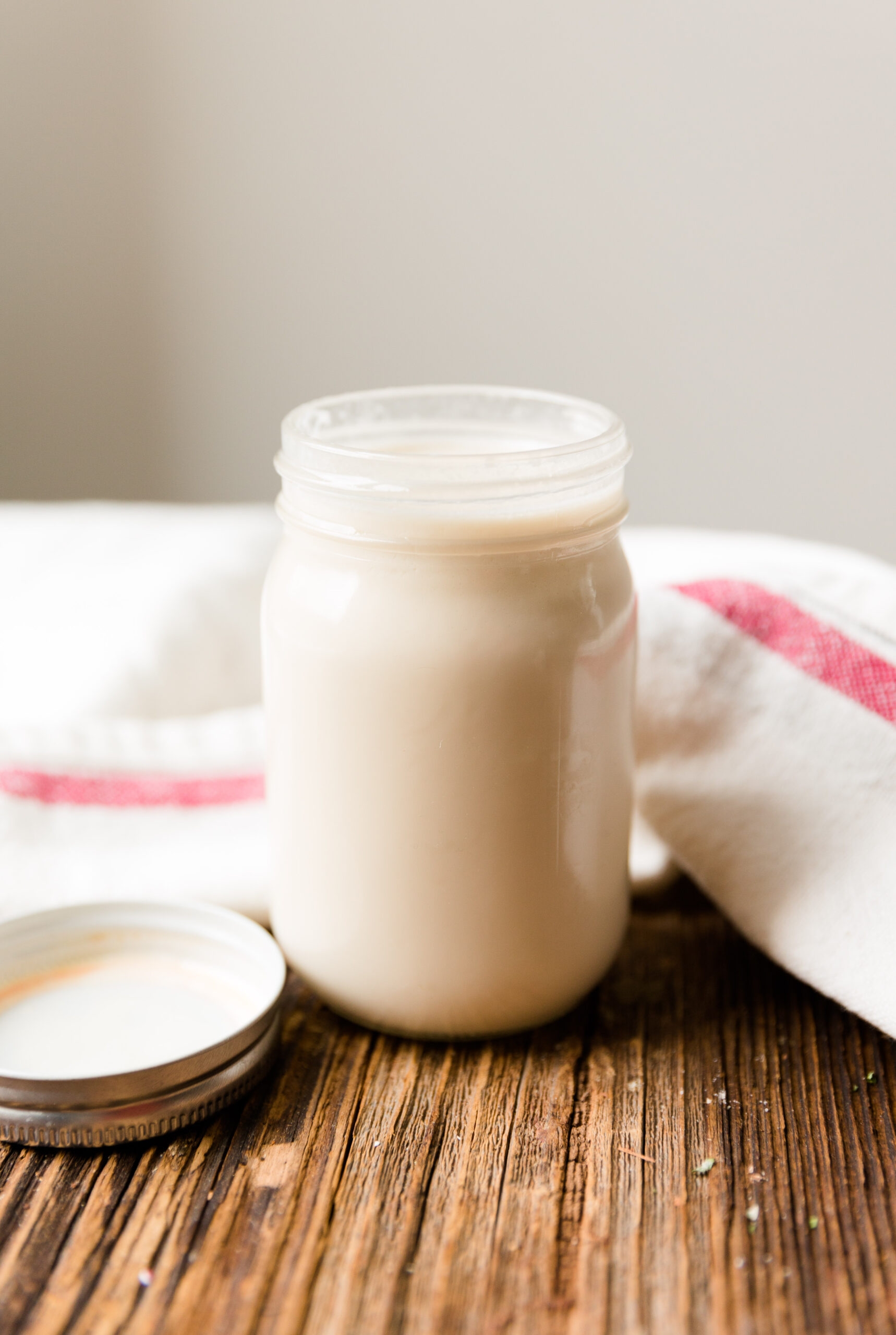 Dairy free vanilla creamer in small glass mason jar.
