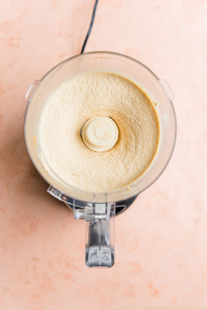 Creamy football ingredients blended in food processor.