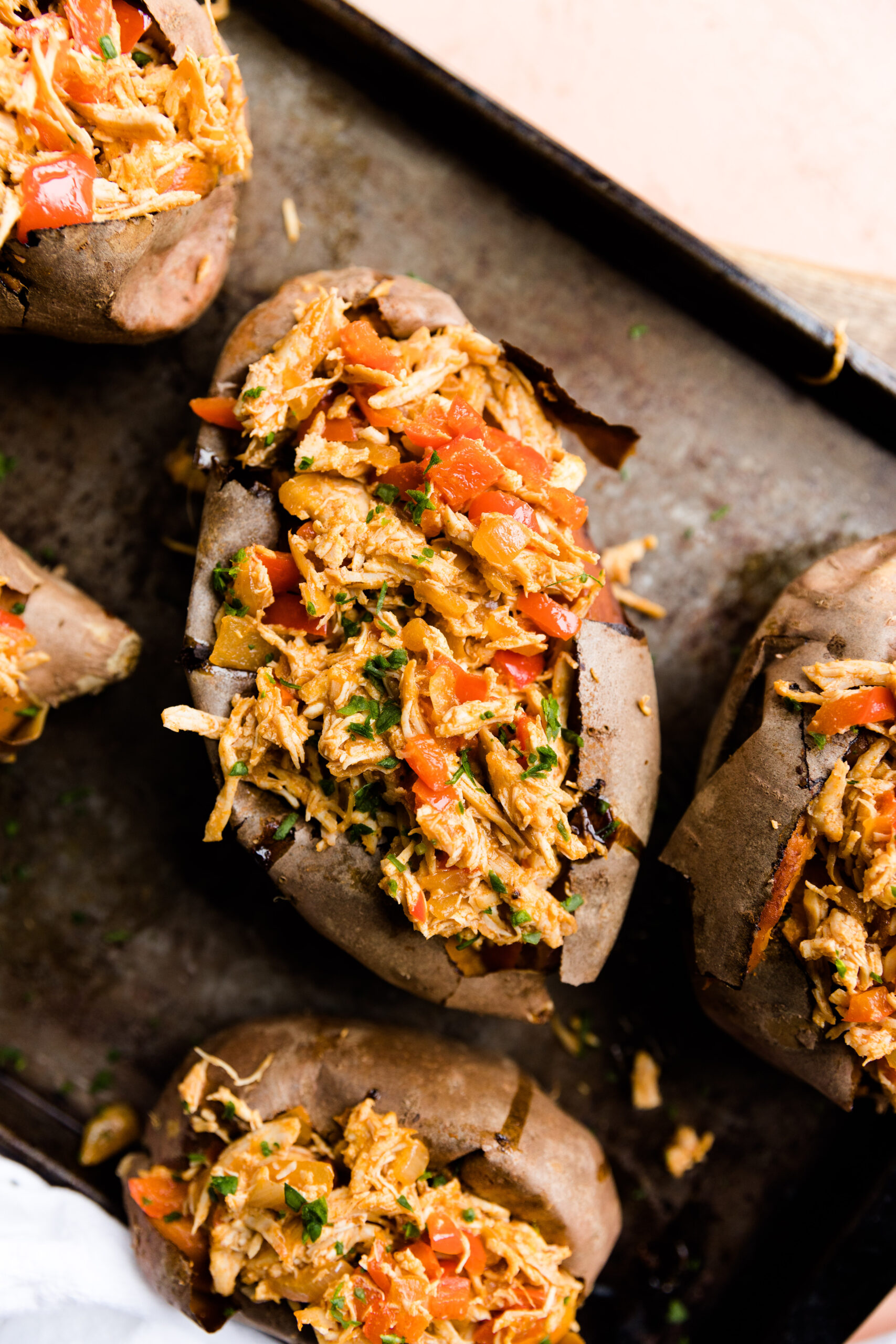 Close up picture of buffalo chicken baked potatoes.