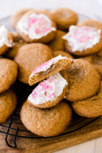 Soft frosted sugar cookie cut in half so you can see the gooey inside.