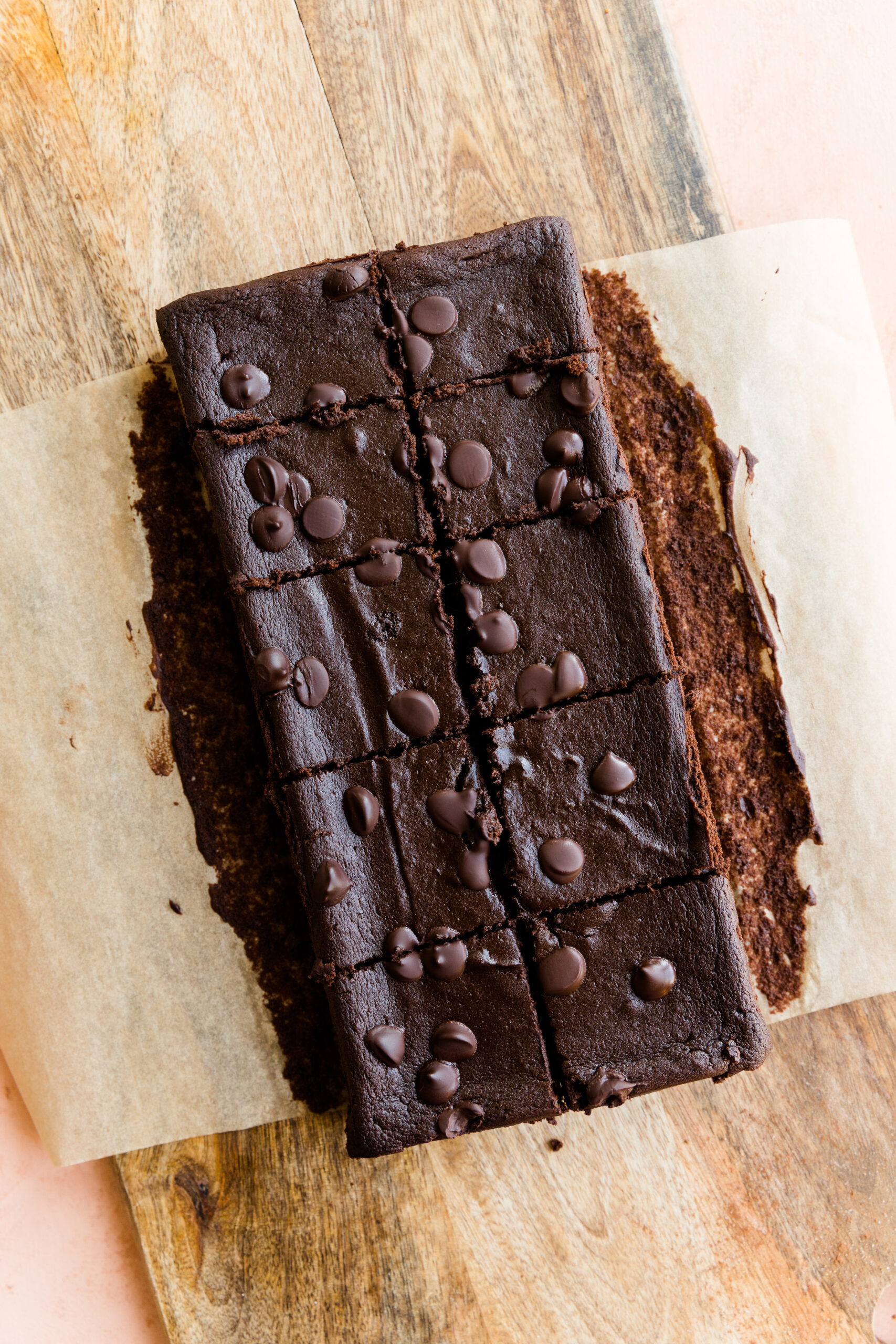 Sweet potato brownies cut into 10 squares on parchment paper.