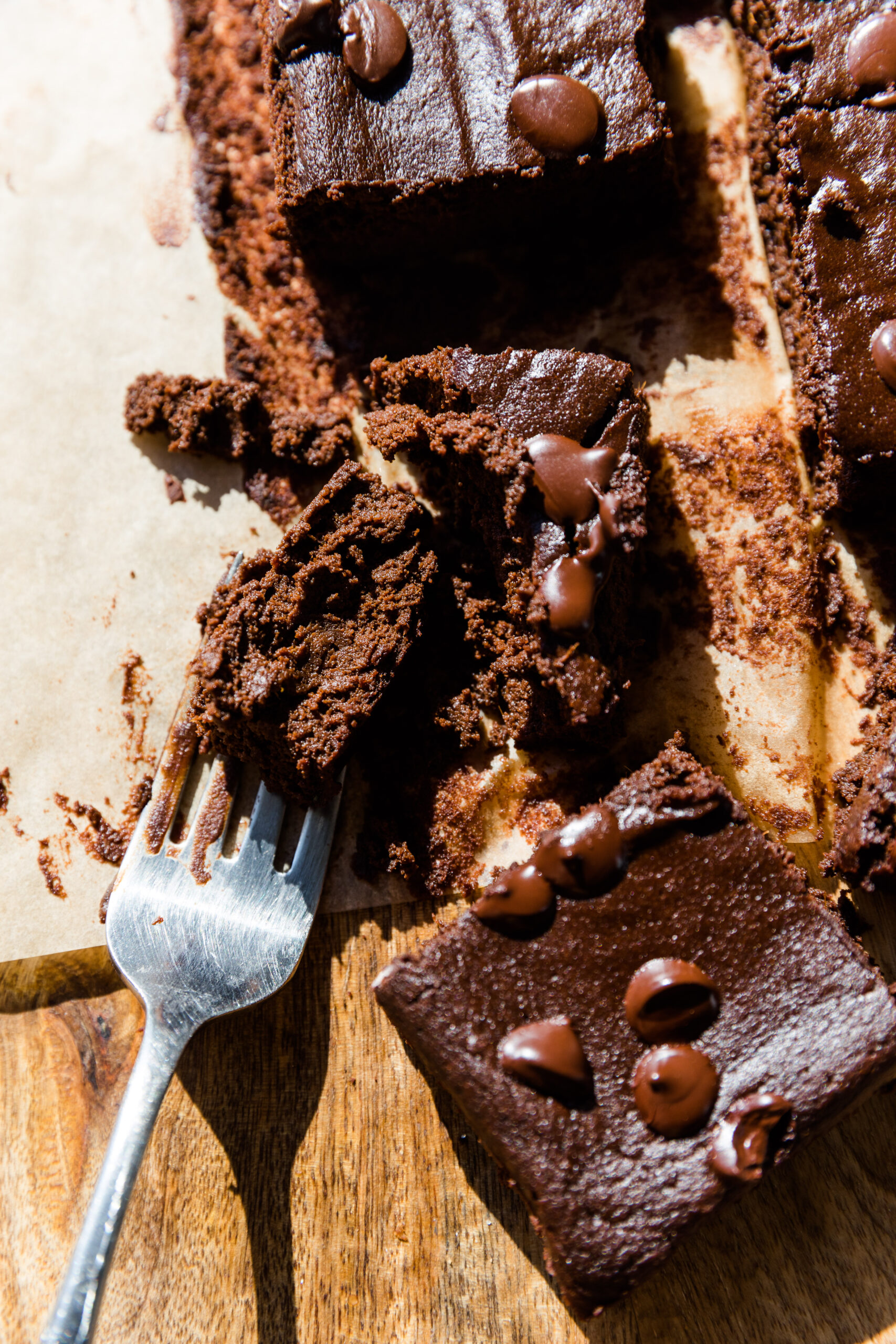 Fork taking a bite out of fudgy sweet potato brownies.
