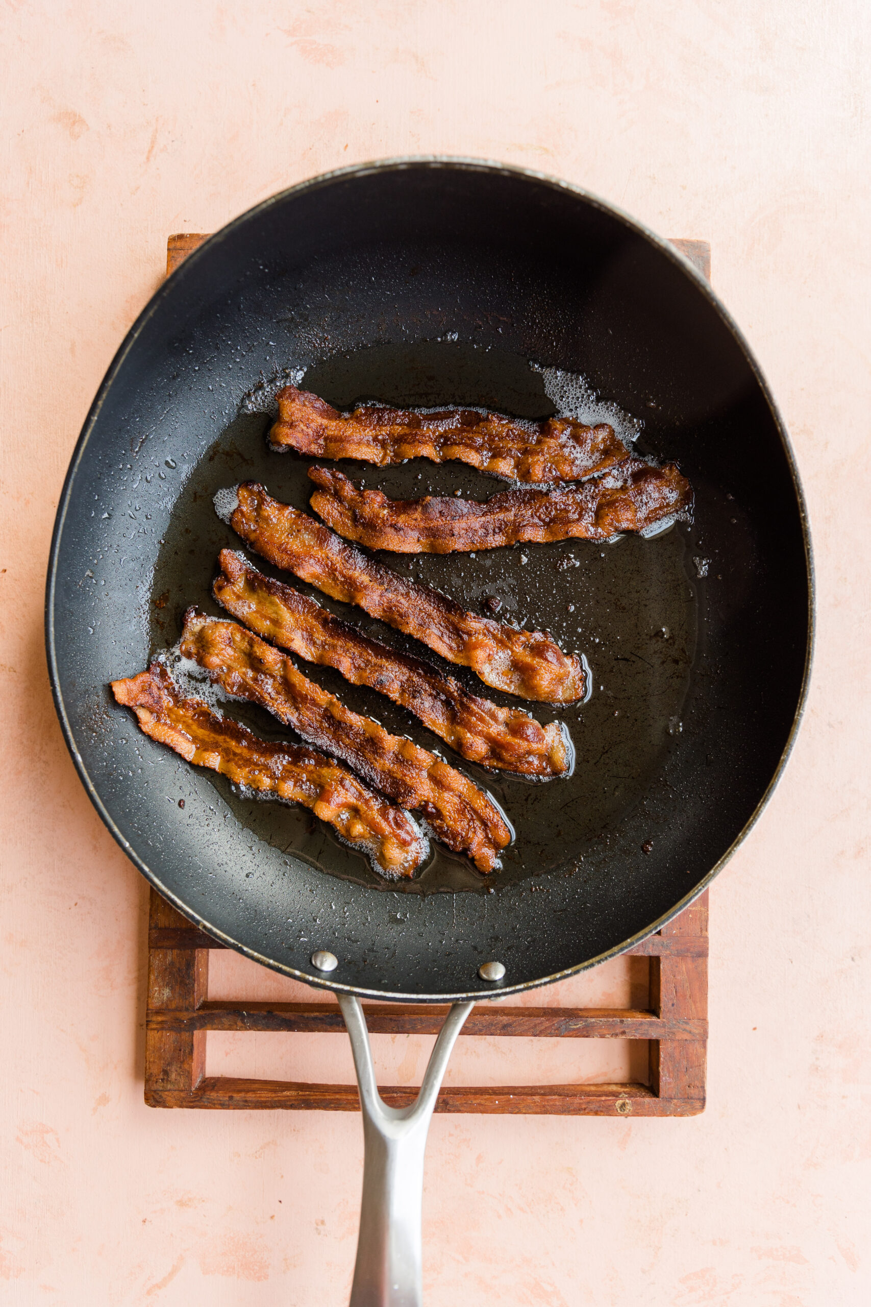 Crispy bacon in skillet.