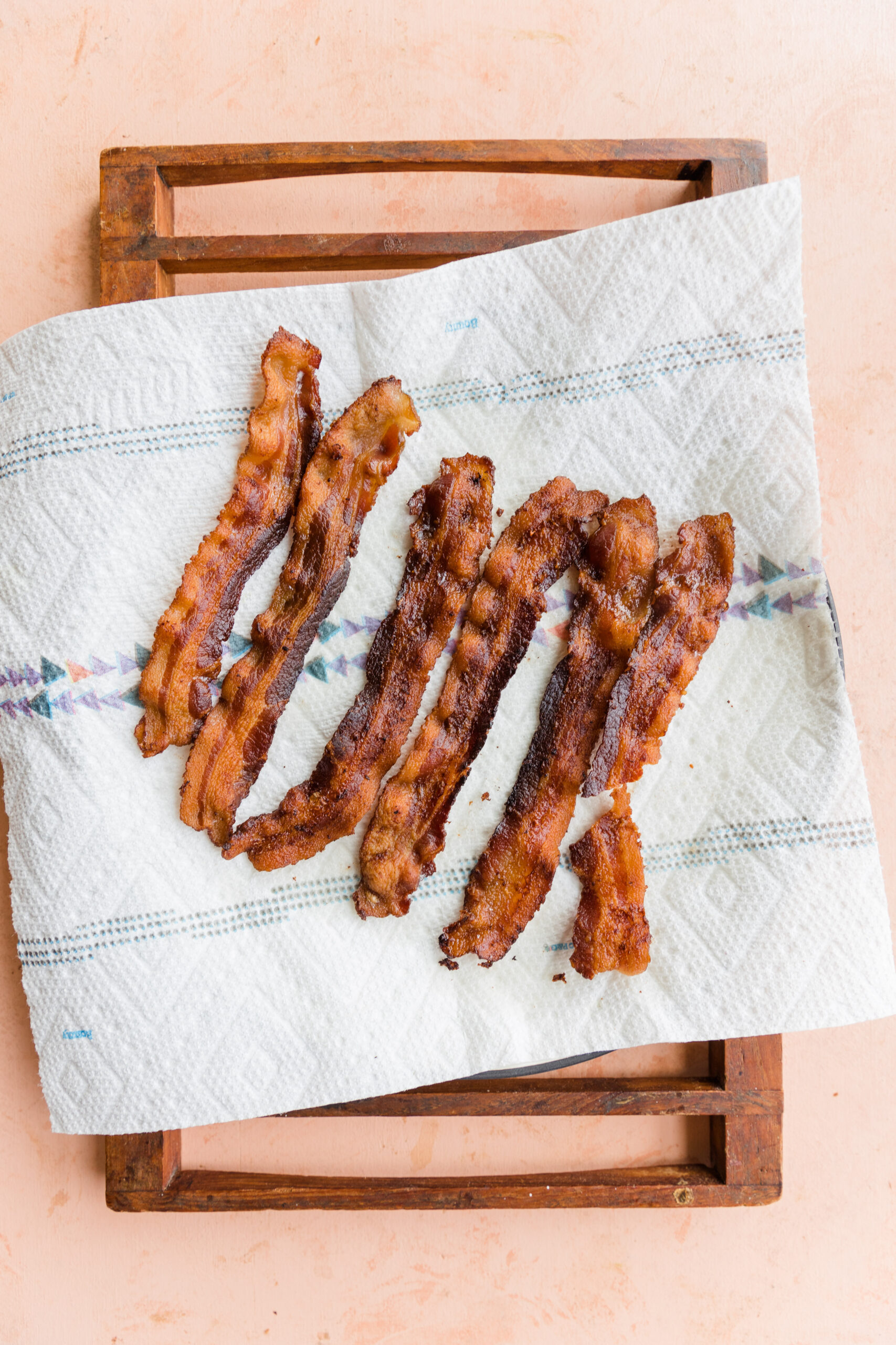 Crispy bacon on paper towel lined plate.