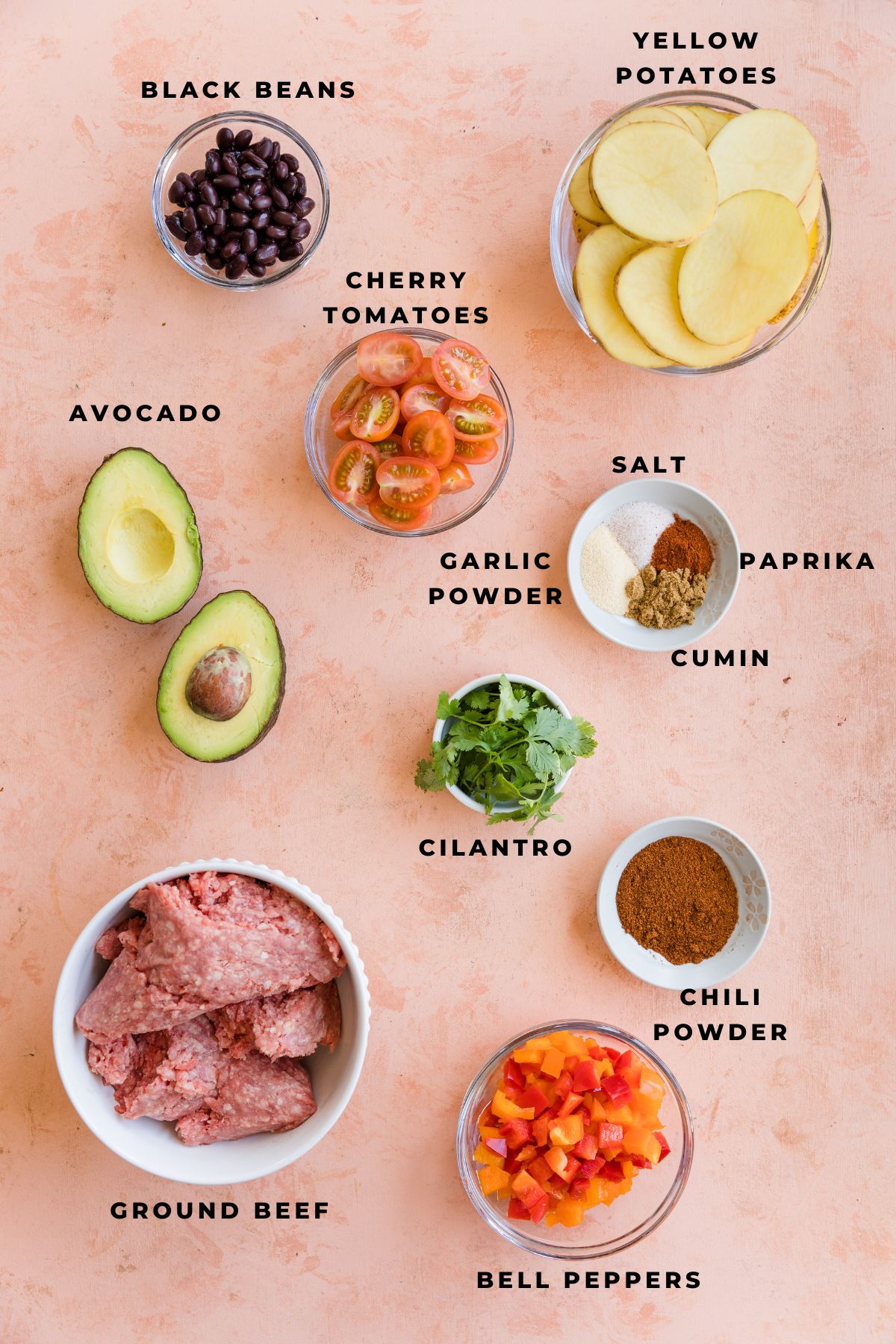 Ingredients for potato nachos measured out in small bowls.