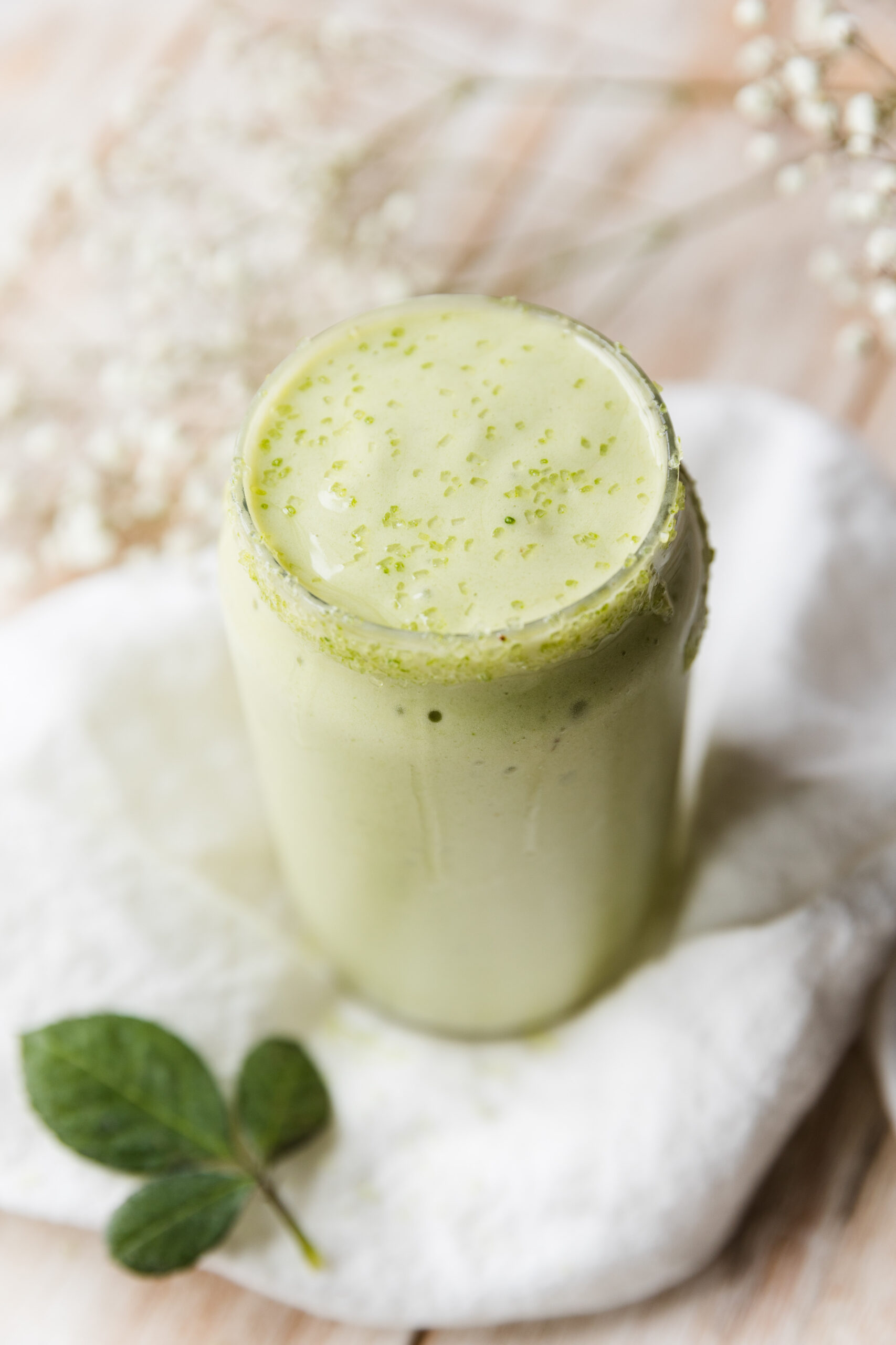 Close up picture of shamrock shake with green sprinkles on top.
