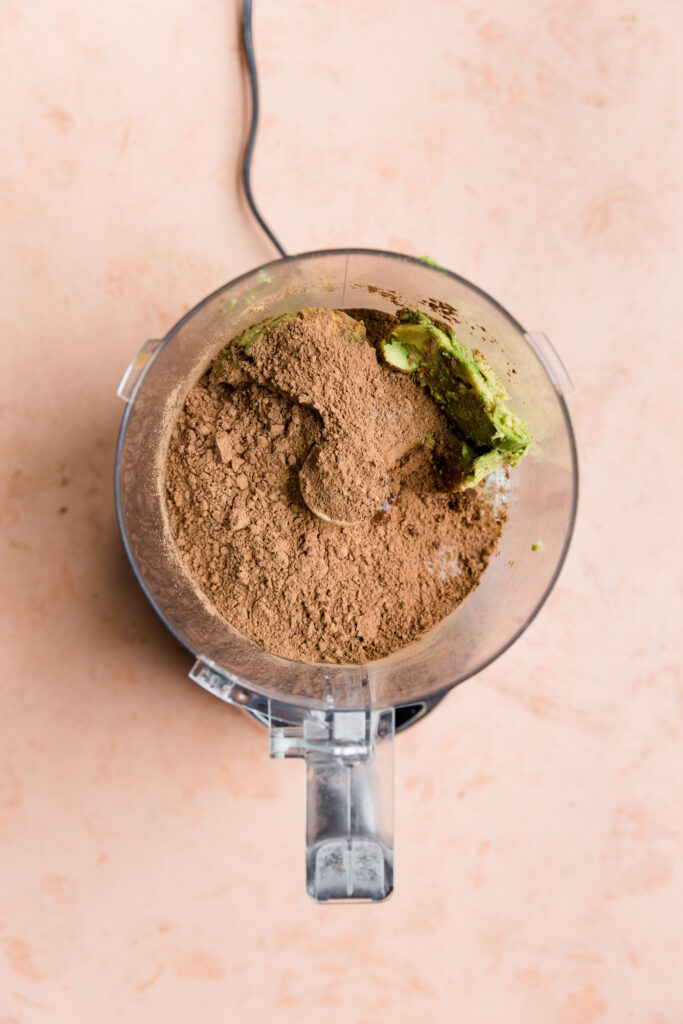 Ingredients for chocolate frosting in food processor. 